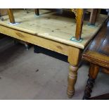 A large polished pine kitchen table, raised on baluster turned legs, W200cm, D90cm, H78cm