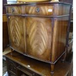 A reproduction mahogany bow-front sideboard, with fitted drawers and cupboards, on tapered legs,