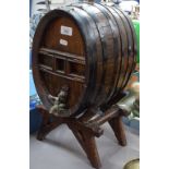 A coopered barrel with tap on wooden stand, height 46cm overall