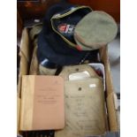 A box of military items - caps, cartridges, book etc