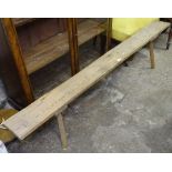 An Antique pine bench, L183cm