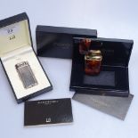 A boxed Dunhill lighter, and an Yves St Laurent boxed lighter
