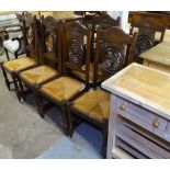 A set of 4 French oak dining chairs, with wheel-design pierced and carved panelled backs, and drop-