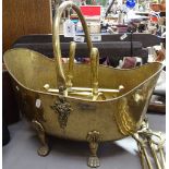 A brass coal bucket on 4 feet, a brass long-handled fire companion set, and a pair of firedogs