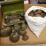 A tin of Victorian bun pennies, crinoline lady bells, and a bag of pennies