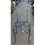 A craftsman made ornate wrought and polished steel side chair, with glass embellishments