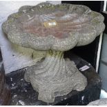 A weathered concrete shell-design birdbath, H40cm