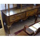 An 18th century cross-banded oak dresser base, with 2 frieze drawers, shaped apron, raised on