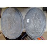 A pair of oval lead plaques, height 36cm