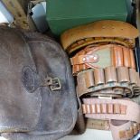 A satchel, cartridge belts, Whiskey glasses, a hip flask etc
