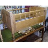 An Antique Continental pine cot, W130cm