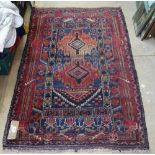 An Antique red ground Beluchi rug, 140cm x 89cm