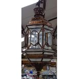 A hexagonal metal-framed hanging lantern with clear glass panels, height 65cm approx