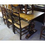 An oak rectangular refectory dining table, raised on carved baluster legs, and a set of 3 spindle-