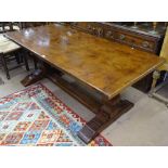 A quality reproduction oak refectory dining table, raised on heavy shaped baluster legs and flat