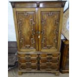 An Antique oak 2-section linen press, the top having a slide fitted interior, with applied moulded