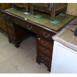 A reproduction mahogany twin-pedestal writing desk