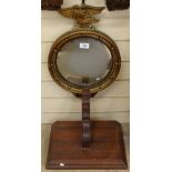 An eagle-crested gilt butler's mirror, and a mahogany clock bracket