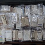 A collection of bundles of cigarette cards