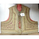 An Eastern gold braid embroidered waistcoat of small size