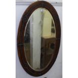 An oval mirror with studded leather frame, L90cm