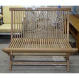 A teak slatted folding garden bench, L100cm