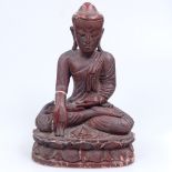 A Burmese carved wood and lacquered Buddha, 30cm