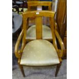 A pair of walnut open armchairs with upholstered seats