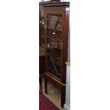 An Edwardian mahogany corner display cabinet on stand, with single glazed door