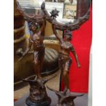 A pair of patinated spelter figures holding mirrors, height 43cm
