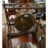 An Edwardian brass gong in stand with striker, height 66cm