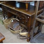 An Ipswich oak style knee-hole writing desk with fitted drawers, on turned legs, W113cm