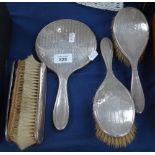 A 5-piece silver-backed dressing table brush and mirror set