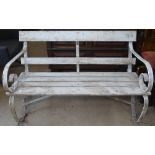 A white painted scrolled and slatted garden bench, W115cm
