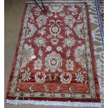 A small red ground Persian design rug, 130cm x 85cm