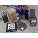 A Bristol blue oil lamp on cast-metal base, 2 GPO test meters, a teapot stand, a sundial etc