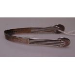 A pair of Edwardian Art Nouveau silver sugar tongs, by Liberty & Company, engraved L&Co, hallmarks