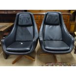 A pair of mid-century low swivel armchairs on a stained wood 4-leg star-base