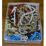 A tray of mixed costume necklaces and beads