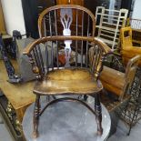 A 19th century elm-seated Windsor bow armchair, with crinoline stretcher, on turned legs