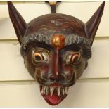 A carved and painted wooden mask in the form of an animal's head, 20.5cm across