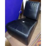 A contemporary designer black leather lounge chair of tapering form