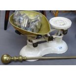 A Boots cast-iron kitchen balance scale with brass pan and weights