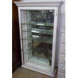 A Victorian painted shop display cabinet, with mirrored back, glass shelves, and single glazed door,