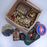 Military badges and buttons, a pipe, a spirit level etc