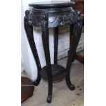 An ebonised Oriental design jardiniere stand, with all over carved decoration and cabriole legs,