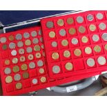 Trays of various coins, including commemorative