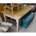 A polished pine farmhouse kitchen table, raised on baluster turned legs, L183cm, H75cm, D92cm