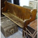 A Gothic stained pine church pew, L190cm