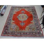 A red ground wool Persian style rug, 265cm x 190cm